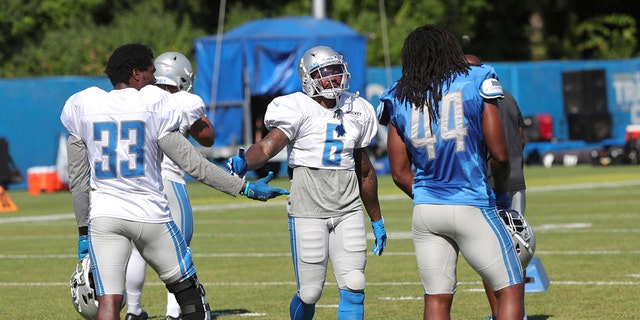 Detroit Lions running back Kerryon Johnson, linebacker Jalen Reeves-Maybin and running back DeAndre Swift (6) talk during NFL football training camp, Thursday, Aug. 20, 2020, in Allen Park, Mich.. (Kirthmon F. Dozier/Detroit Free Press via AP, Pool)