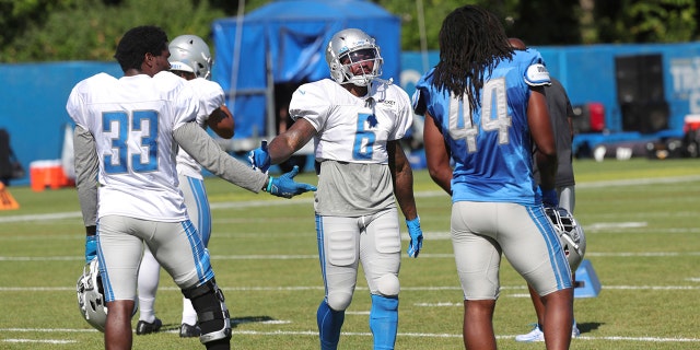 Detroit Lions running back Kerryon Johnson, linebacker Jalen Reeves-Maybin and running back DeAndre Swift (6) talk during NFL football training camp, Thursday, Aug. 20, 2020, in Allen Park, Mich.. (Kirthmon F. Dozier/Detroit Free Press via AP, Pool)