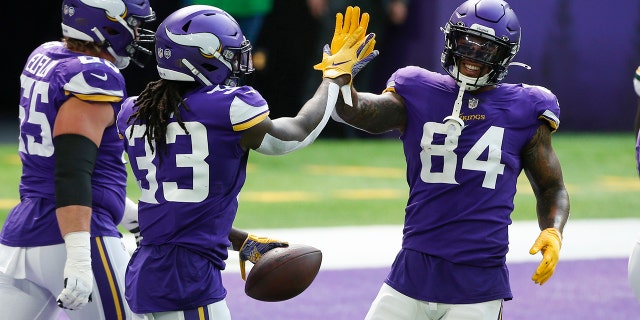 Minnesota Vikings running back Dalvin Cook celebrates with teammate Irv Smith (84) after scoring on a 1-yard touchdown run during the first half of an NFL football game against the Green Bay Packers, Sunday, Sept. 13, 2020, in Minneapolis. (AP Photo/Bruce Kluckhohn)