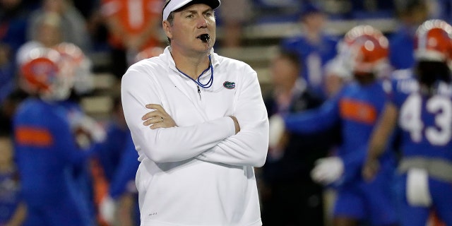 Florida head coach Dan Mullen watches his players warm up before an NCAA college football game against Florida State, in Gainesville, Fla. Mullen is still wary about what lies ahead as Florida prepares to open the season at Ole Miss on Saturday, Sept. 26, 2020. “Obviously, all the COVID stuff makes you anxious,” Mullen said. (AP Photo/John Raoux, File)