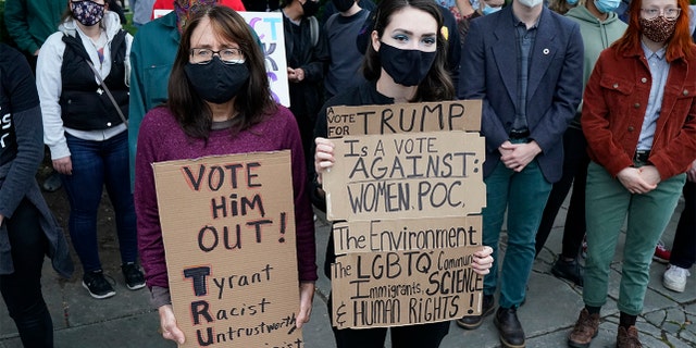 Protesters listen to speakers at a rally near the debate hall, Tuesday, Sept. 29, 2020, in Cleveland. The first presidential debate between Republican candidate President Donald Trump and Democratic candidate and former Vice President Joe Biden is being held in Cleveland on Tuesday. (AP Photo/Tony Dejak)