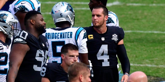 Las Vegas Raiders quarterback Derek Carr and Carolina Panthers quarterback Teddy Bridgewater meet on the field after an NFL football game Sunday, Sept. 13, 2020, in Charlotte, N.C. (AP Photo/Mike McCarn)