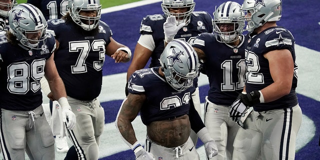 Dallas Cowboys running back Ezekiel Elliott (21) celebrates after scoring a touchdown against the Los Angeles Rams during the first half of an NFL football game Sunday, Sept. 13, 2020, in Inglewood, Calif. (AP Photo/Jae C. Hong )