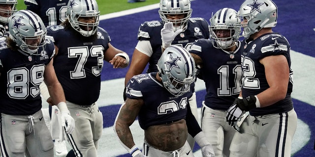 Dallas Cowboys running back Ezekiel Elliott (21) celebrates after scoring a touchdown against the Los Angeles Rams during the first half of an NFL football game Sunday, Sept. 13, 2020, in Inglewood, Calif. (AP Photo/Jae C. Hong )