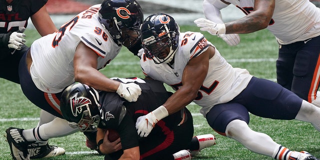 Chicago Bears outside linebacker Khalil Mack (52) and Chicago Bears defensive tackle Akiem Hicks (96) sack Atlanta Falcons quarterback Matt Ryan (2) during the second half of an NFL football game, Sunday, Sept. 27, 2020, in Atlanta. (AP Photo/John Bazemore)