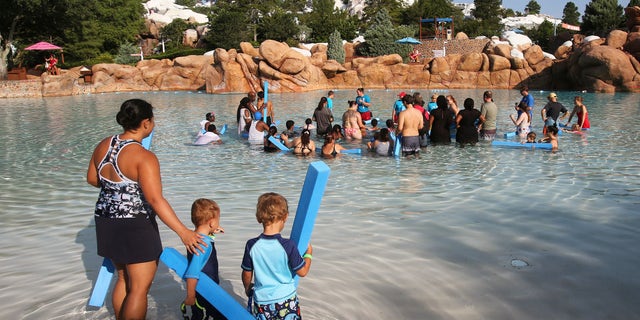 A woman and her sons at Disney's Blizzard Beach Water Park in June 2019. (Joe Burbank/Orlando Sentinel/Tribune News Service via Getty Images)