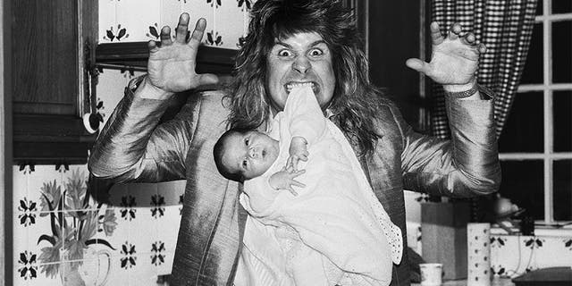 Ozzy Osbourne, former lead singer of Black Sabbath, pictured at home two weeks after the birth of his baby boy Jack on November 25, 1985.