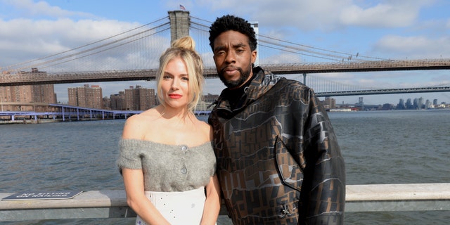 Sienna Miller (L) and Chadwick Boseman (R) starred together in the action thriller 2019 film '21 Bridges.' 