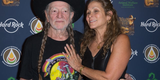 Willie Nelson and Annie D'Angelo attend Hard Rock International's Wille Nelson Artist Spotlight Benefit Concert