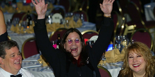 Black Sabbath lead singer and MTV star British Ozzy Osbourne (C) parties at the 2002 annual White House Correspondents Dinner on May 4, 2002, in Washington, DC. US actor/comedian Drew Carey is the featured entertainment for the dinner with attracts leading political figures and Hollywood stars.