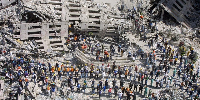 Rescue workers sift through the wreckage of the World Trade Center Sept. 13, 2001 in New York City, two days after two hijacked airplanes slammed into the twin towers, levelling them in an alleged terrorist attack. (Mario Tama/Getty Images)