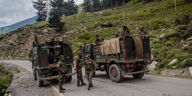 An Indian army convoy carrying reinforcements and supplies drives on a highway bordering China on Sept. 2 in Gagangir, India. (Getty Images)