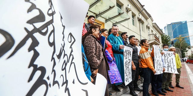 Mongolians protest at the Ministry of Foreign Affairs in Ulaanbaatar, the capital of Mongolia, against China's plan to introduce Mandarin-only classes at schools in the neighboring Chinese province of Inner Mongolia on Monday. (Photo by Byambasuren Byamba-Ochir/AFP via Getty Images)