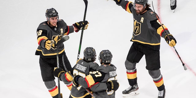 Vegas Golden Knights' Shea Theodore (27) celebrates his goal against the Vancouver Canucks with teammates Reilly Smith (19), Jonathan Marchessault (81) and Max Pacioretty (67) during the third period of Game 7 of an NHL hockey second-round playoff series, Friday, Sept. 4, 2020, in Edmonton, Alberta. (AP)
