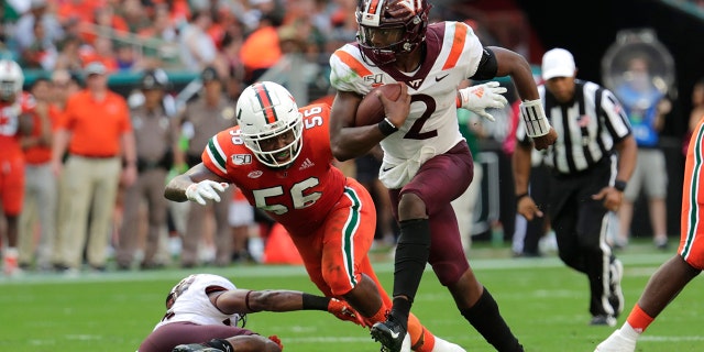 In this Saturday, Oct. 5, 2019, file photo, Virginia Tech quarterback Hendon Hooker (2) runs as Miami linebacker Michael Pinckney (56) defends during the first half of an NCAA college football game in Miami Gardens, Fla. Virginia Tech plays North Carolina State on Saturday, Sept. 26. (AP Photo/Lynne Sladky)