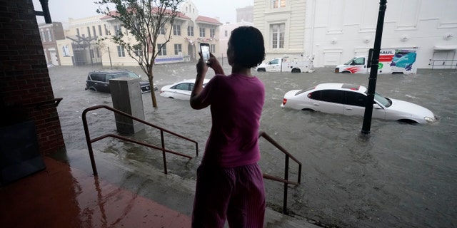 Flood waters move on the street, Wednesday, Sept. 16, 2020, in downtown Pensacola, Fla. Hurricane Sally made landfall Wednesday near Gulf Shores, Alabama, as a Category 2 storm, pushing a surge of ocean water onto the coast and dumping torrential rain that forecasters said would cause dangerous flooding from the Florida Panhandle to Mississippi and well inland in the days ahead.