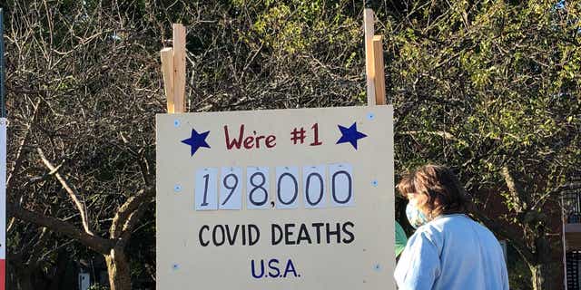 A 'scoreboard' showing the coronavirus death toll was put on display in Northbrook, IL