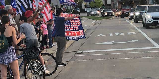 A pro-Trump group gathers Friday after an anti-Trump display was unveiled in Northbrook, Ill.