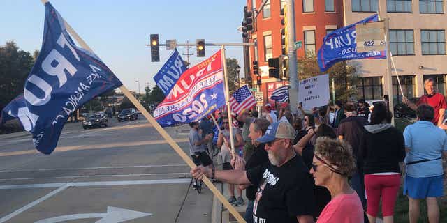 A group of Trump supporters wave flags in the northern Chicago suburb of Northbrook on Sept. 25.