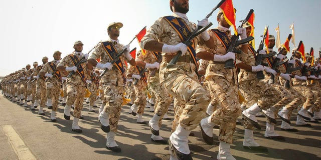 FILE- Members of the Iranian revolutionary guard march during a parade to commemorate the anniversary of the Iran-Iraq war