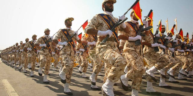 FILE- Members of the Iranian Revolutionary Guard march during a parade to commemorate the anniversary of the Iran-Iraq war