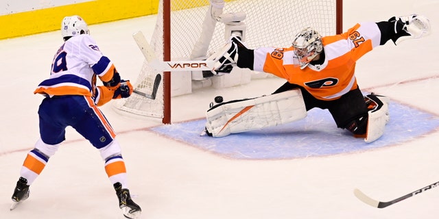 New York Islanders center Brock Nelson (29) scores against Philadelphia Flyers goaltender Carter Hart (79) during second-period NHL Stanley Cup Eastern Conference playoff hockey game action in Toronto, Saturday, Sept. 5, 2020. (Frank Gunn/The Canadian Press via AP)