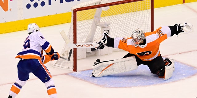 New York Islanders center Brock Nelson (29) scores against Philadelphia Flyers goaltender Carter Hart (79) during second-period NHL Stanley Cup Eastern Conference playoff hockey game action in Toronto, Saturday, Sept. 5, 2020. (Frank Gunn/The Canadian Press via AP)