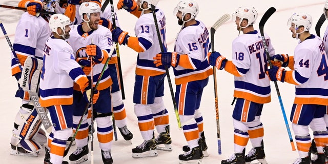 New York Islanders celebrate defeating the Philadelphia Flyers after third-period NHL Stanley Cup Eastern Conference playoff hockey game action in Toronto, Saturday, Sept. 5, 2020. (Frank Gunn/The Canadian Press via AP)