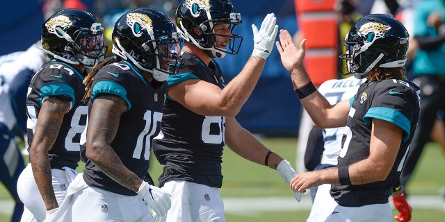 Jacksonville Jaguars tight end Tyler Eifert (88) is congratulated by quarterback Gardner Minshew, right, after teaming up for a 19-yard touchdown pass against the Tennessee Titans in the first half of an NFL football game Sunday, Sept. 20, 2020, in Nashville, Tenn. (AP Photo/Mark Zaleski)