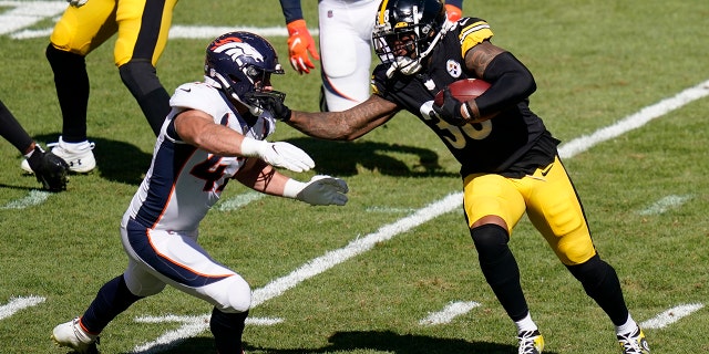 Pittsburgh Steelers running back Jaylen Samuels (38) stiff-arms Denver Broncos inside linebacker Josey Jewell (47) during the second half of an NFL football game, Sunday, Sept. 20, 2020, in Pittsburgh. (AP Photo/Keith Srakocic)