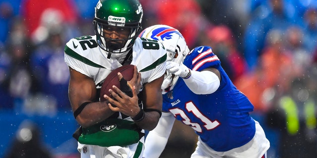 File-New York Jets wide receiver Jamison Crowder (82) catches a pass for a touchdown in front of Buffalo Bills' Dean Marlowe (31) during the second half of an NFL football game Sunday, Dec. 29, 2019, in Orchard Park, N.Y. (AP Photo/Adrian Kraus, File)