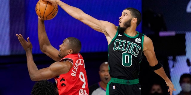 Boston Celtics' Jayson Tatum (0) blocks the shot of Toronto Raptors' Serge Ibaka (9) during the second half of an NBA conference semifinal playoff basketball game Monday, Sept. 7, 2020, in Lake Buena Vista, Fla. (AP Photo/Mark J. Terrill)