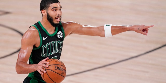 Boston Celtics' Jayson Tatum directs a play during the second half of an NBA Eastern Conference finals game against the Miami Heat Friday, Sept. 25, 2020, in Lake Buena Vista, Fla. (AP Photo/Mark J. Terrill)