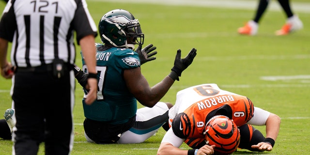 Cincinnati Bengals' Joe Burrow (9) reacts after a hit by Philadelphia Eagles' Malik Jackson (97) during the first half of an NFL football game, Sept.. 27, in Philadelphia. (AP Photo/Chris Szagola)
