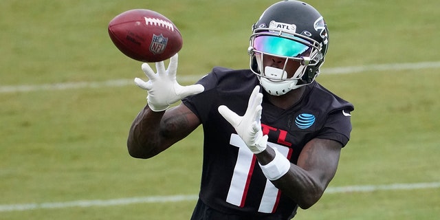 Atlanta Falcons wide receiver Julio Jones (11) makes a catch during an NFL training camp football practice Sunday, Aug. 23, 2020, in Atlanta. (AP Photo/John Bazemore, Pool)