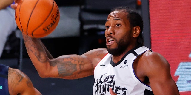 The Los Angeles Clippers' Kawhi Leonard grabs a rebound against the Dallas Mavericks during the second quarter of Game 4 of an NBA basketball first-round playoff series, Sunday, Aug. 23, 2020, in Lake Buena Vista, Fla. (Kevin C. Cox/Pool Photo via AP)