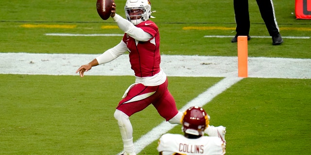 Arizona Cardinals quarterback Kyler Murray (1) scores a touchdown as Washington Football Team strong safety Landon Collins (26) looks on during the first half of an NFL football game, Sunday, Sept. 20, 2020, in Glendale, Ariz. (AP Photo/Ross D. Franklin)