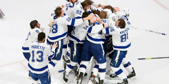 Tampa Bay Lightning players celebrate after defeating the Dallas Stars to win the Stanley Cup in Edmonton, Alberta, on Monday, Sept. 28, 2020. (Jason Franson/The Canadian Press via AP)