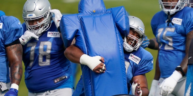 Detroit Lions defensive tackle John Penisini hits a tackling dummy during drills at the Lions NFL football practice, Tuesday, Sept. 1, 2020, in Allen Park, Mich. (AP Photo/Carlos Osorio)