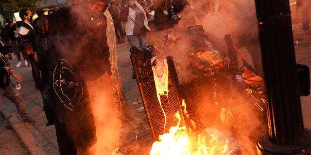 A fire burns in downtown Louisville, Ky., after a grand jury indicted one officer on criminal charges six months after Breonna Taylor was fatally shot by police.(Associated Press)