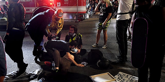 A protester who was hit by a car receives assistance from paramedics in Hollywood, Calif., Sept. 24, 2020. (Getty Images)
