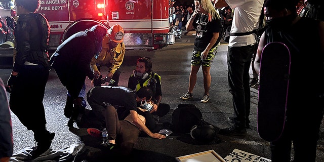 A protester who was hit by a car receives assistance from paramedics in Hollywood, Calif., Sept. 24, 2020. (Getty Images)