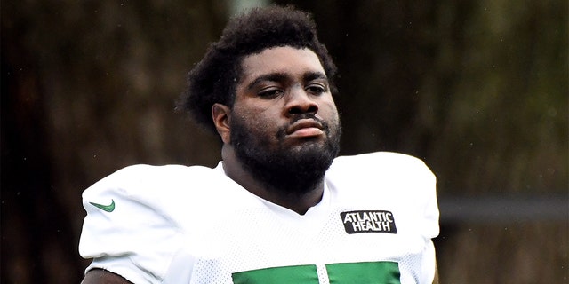 Mekhi Becton #77 of the New York Jets looks on during training camp at Atlantic Health Jets Training Center on August 19, 2020 in Florham Park, New Jersey.