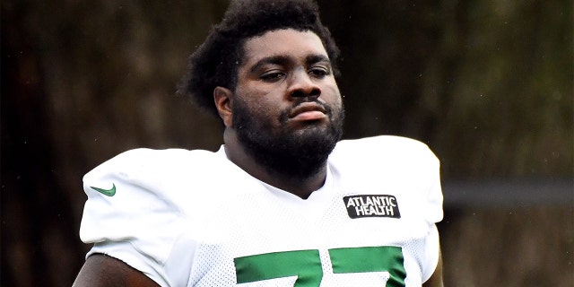 Mekhi Becton #77 of the New York Jets looks on during training camp at Atlantic Health Jets Training Center on August 19, 2020 in Florham Park, New Jersey.