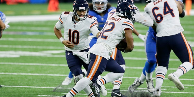 Chicago Bears quarterback Mitchell Trubisky (10) hands off to running back David Montgomery (32) in the second half of an NFL football game in Detroit, Sunday, Sept. 13, 2020. (AP Photo/Duane Burleson)