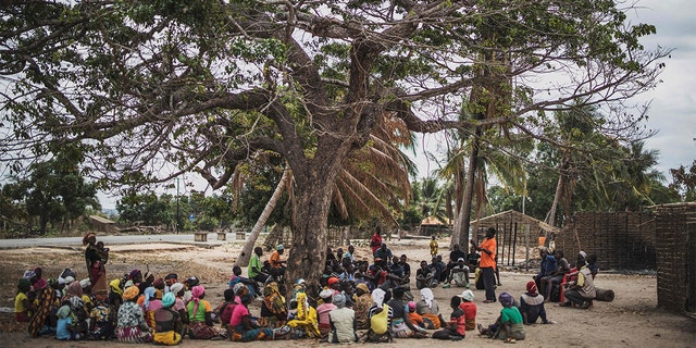 Residents gather for a meeting in the recently attacked village of Aldeia da Paz outside Macomia, on August 24, 2019. - On August 1, the inhabitants of Aldeia da Paz joined the long list of victims of a faceless Islamist group that has been sowing death and terror for nearly two years in the north of the country, which welcomes from September 4 the Pope. (Photo by MARCO LONGARI / AFP) (Photo by MARCO LONGARI/AFP via Getty Images)