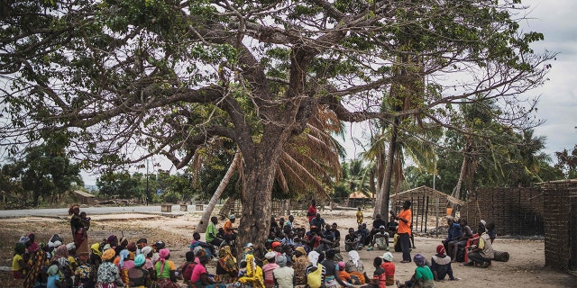 Residents gather for a meeting in the recently attacked village of Aldeia da Paz outside Macomia, on August 24, 2019. - On August 1, the inhabitants of Aldeia da Paz joined the long list of victims of a faceless Islamist group that has been sowing death and terror for nearly two years in the north of the country, which welcomes from September 4 the Pope. (Photo by MARCO LONGARI / AFP) (Photo by MARCO LONGARI/AFP via Getty Images)
