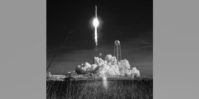 Northrop Grumman's Antares rocket, with Cygnus resupply spacecraft onboard, launches from Pad-0A, Wednesday, April 17, 2019 at NASA's Wallops Flight Facility in this black and white infrared photograph.