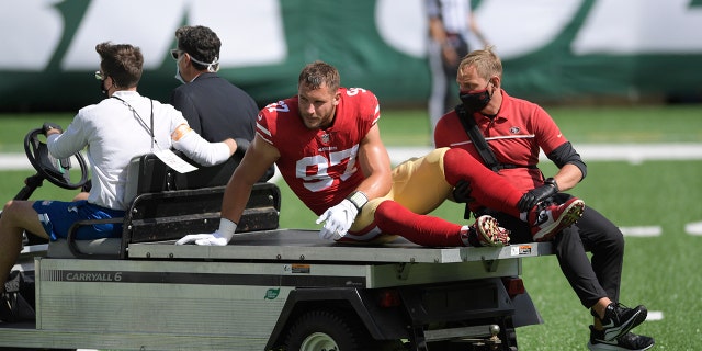 San Francisco 49ers defensive end Nick Bosa is carted off the field after being injured during the first half of an NFL football game against the New York Jets, Sunday, Sept. 20, 2020, in East Rutherford, N.J. (AP Photo/Bill Kostroun)
