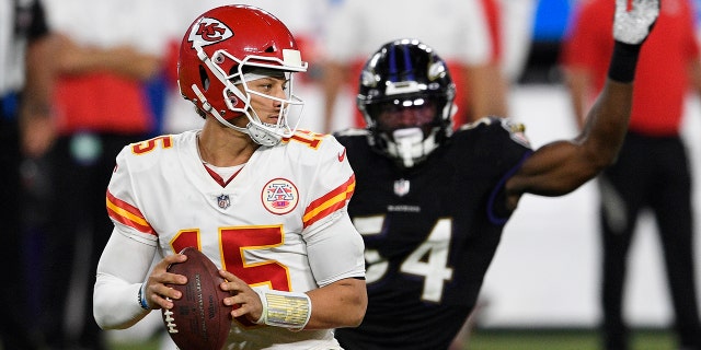 Kansas City Chiefs quarterback Patrick Mahomes (15) looks to pass under pressure from Baltimore Ravens linebacker Tyus Bowser (54) during the second half of an NFL football game, Monday, Sept. 28, 2020, in Baltimore. (AP Photo/Nick Wass)